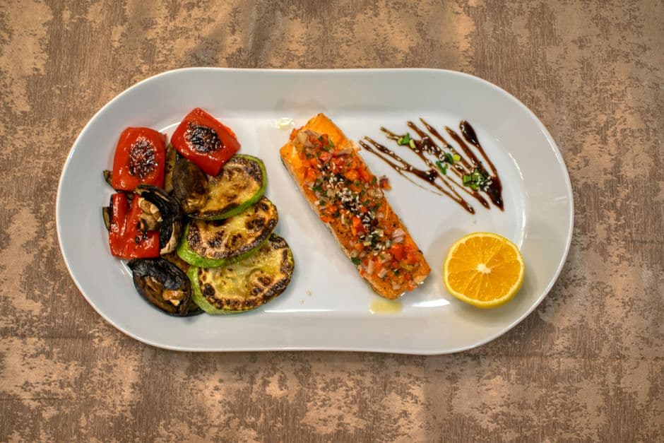 Home-cooked salmon fillet plated with grilled zucchini and peppers